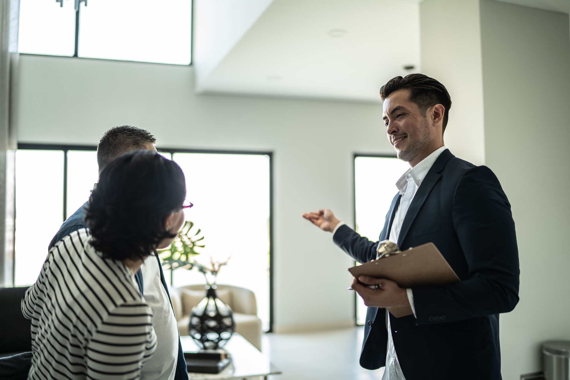 Real estate agent showing house to a couple